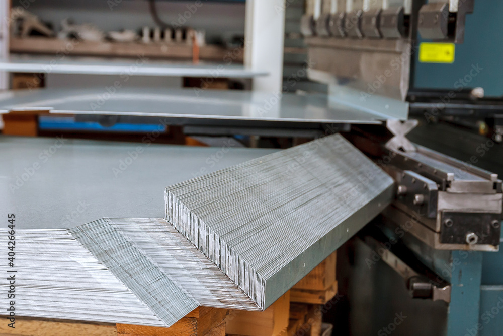 Sheet metal products are stacked on a pallet after a bending process. Sheet metal products are stacked on a pallet after a bending process.