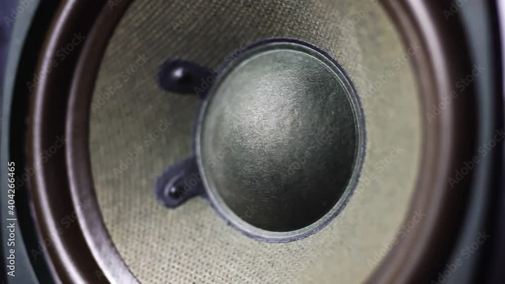 Close up of loud bass speaker vibration on black background. Close up of loud bass speaker vibration on black background.