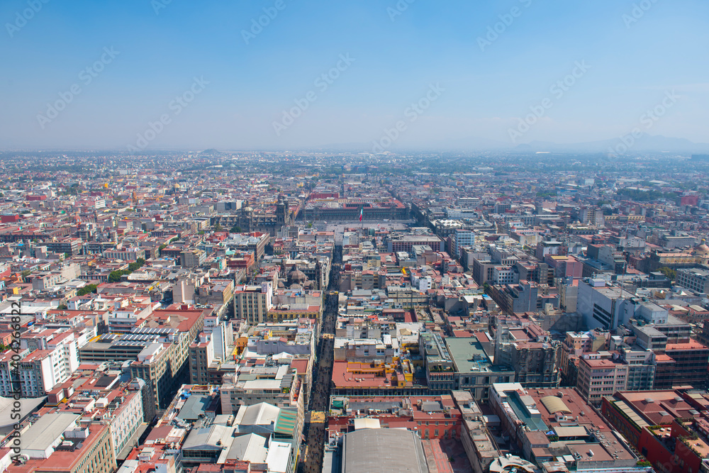 Mexico National Flag on Zocalo Constitution Square and Metropolitan Cathedral aerial view, from Torre Latinoamericana, Mexico City, Mexico. Historic center of Mexico City is a World Heritage Site. 