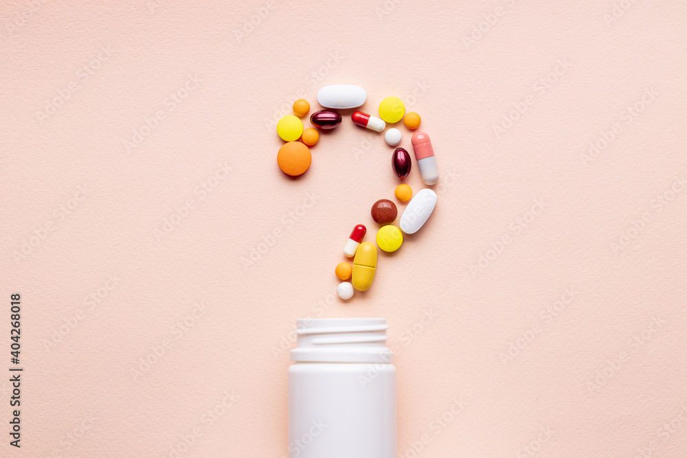 medicine pills question mark symbol isolated over pink background. medical decision concept medicine pills question mark symbol isolated over pink background. medical decision concept