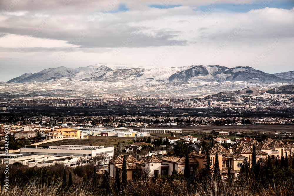 Obraz premium landscape with snowy mountains and Granada city line