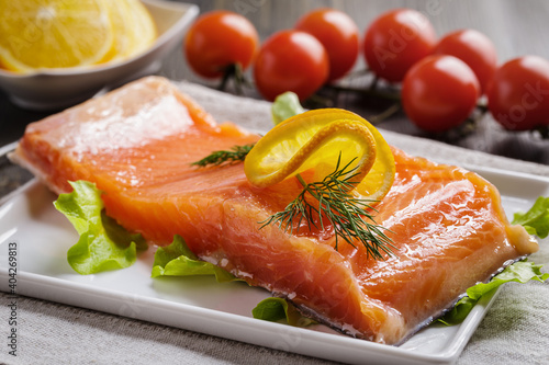 Fresh salted salmon fillet with lemon and dill
