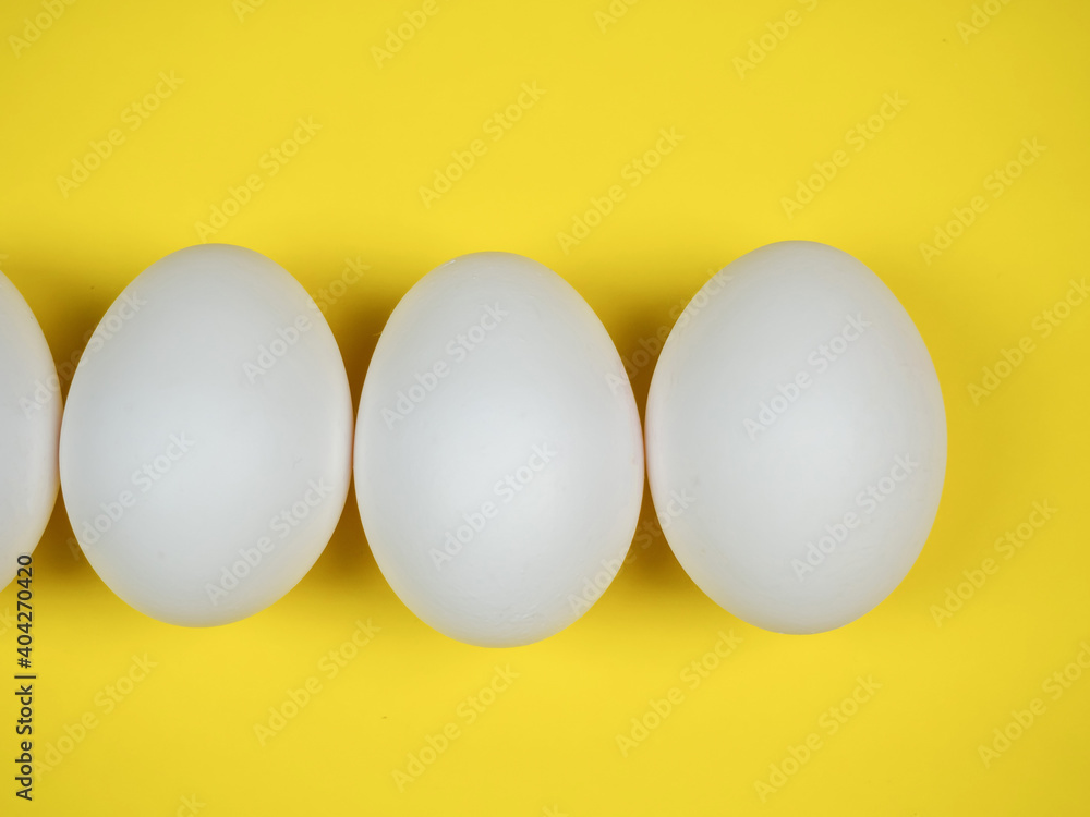 White eggs on a yellow background. White eggs on a yellow background.