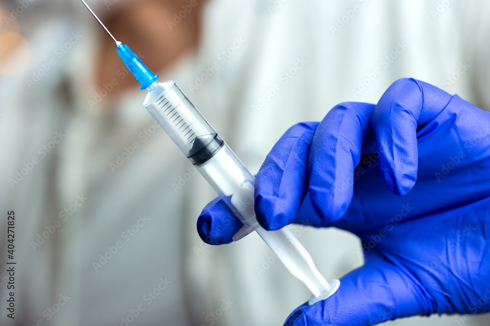 Doctor, nurse, scientist hand in blue gloves holding flu, measles, coronavirus, covid-19 vaccine disease preparing for child, baby, adult, man and woman vaccination shot, medicine and drug concept. Doctor, nurse, scientist hand in blue gloves holding flu, measles, coronavirus, covid-19 vaccine disease preparing for child, baby, adult, man and woman vaccination shot, medicine and drug concept.