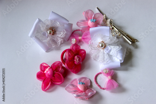 Beautiful hairpins and bows for hair on a white background. View from above.