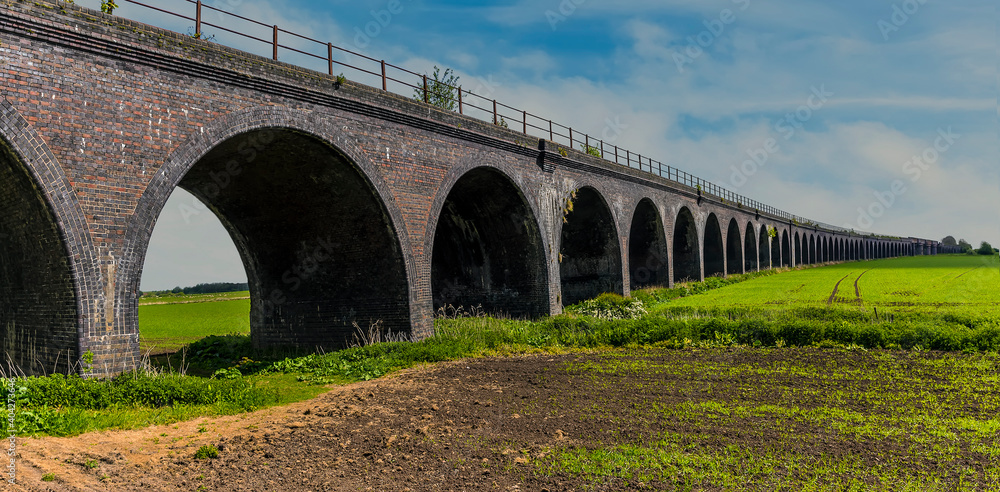 Fototapeta premium A view of the impressive 59 arches of the abandoned railway viaduct at Fledborough, Nottinghamshire in springtime