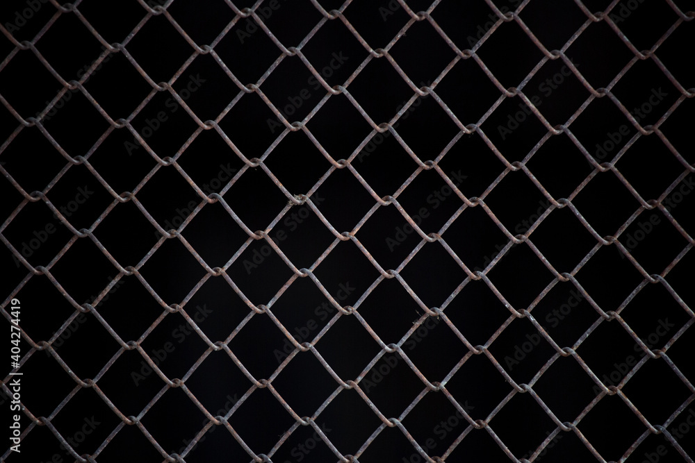 Texture of rusty iron mesh, on a black background Texture of rusty iron mesh, on a black background