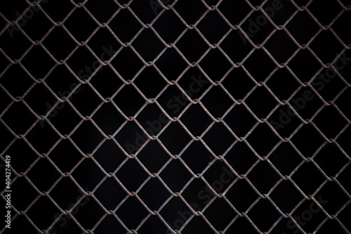 Texture of rusty iron mesh, on a black background