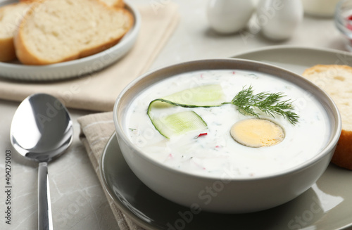 Delicious cold summer soup on light table, closeup