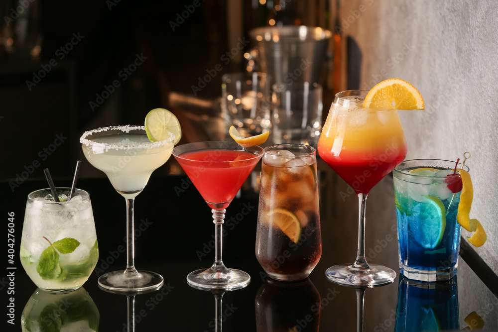 Different delicious cocktails on black table in bar Different delicious cocktails on black table in bar