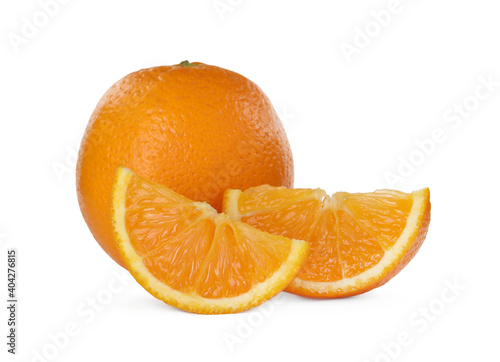 Cut and whole ripe oranges on white background