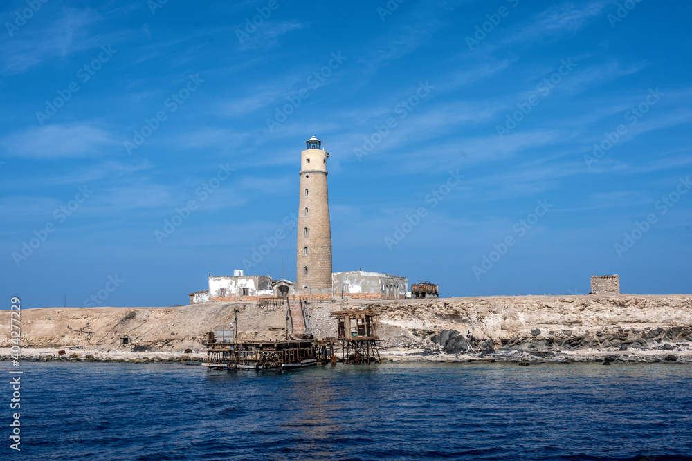 an ancient lighthouse stands in the middle of trade sea routes in the Red Sea