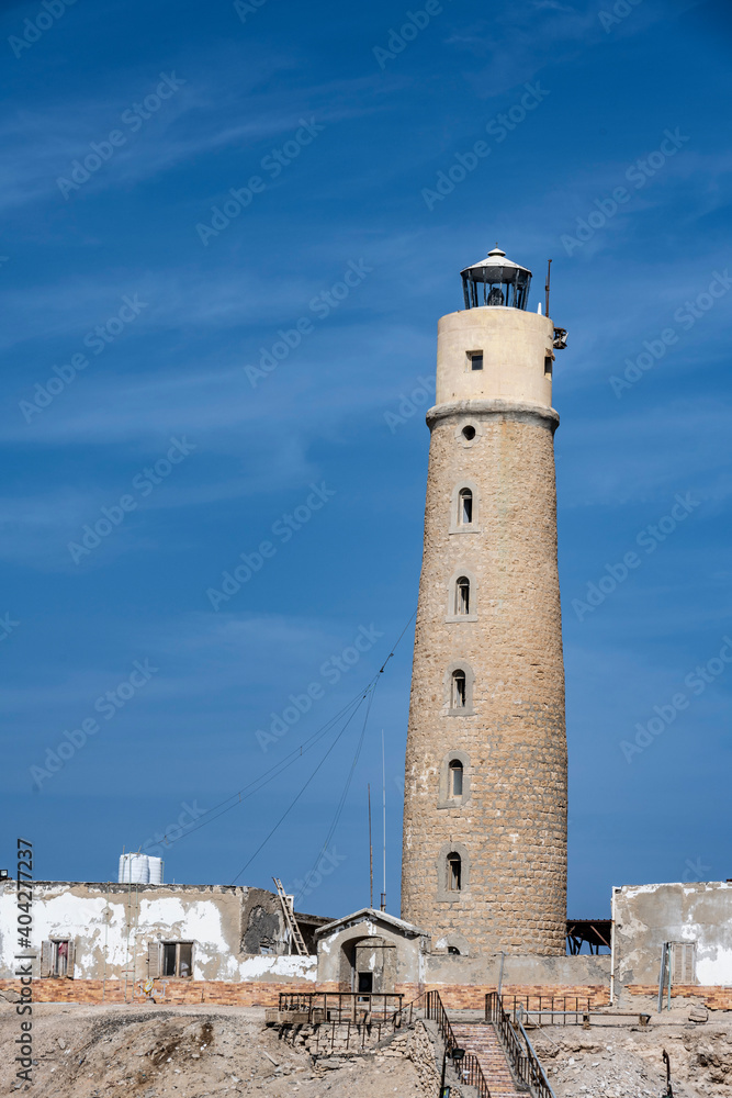 an ancient lighthouse stands in the middle of trade sea routes in the Red Sea