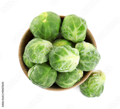 Fresh Brussels sprouts in bowl isolated on white, top view