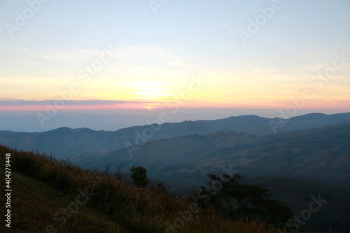 The scenery on the top of the mountain in the morning, mountain peaks in morning fog, at phu lom lo, Loei, Thailand. 