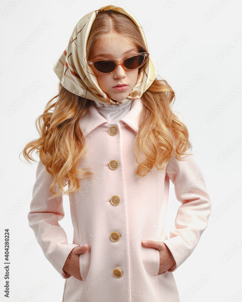 Stylish little girl in a pink coat and sunglasses. Stylish little girl in a pink coat and sunglasses.
