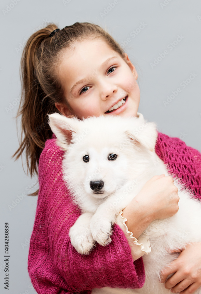 smiling girl gently hugs a puppy smiling girl gently hugs a puppy