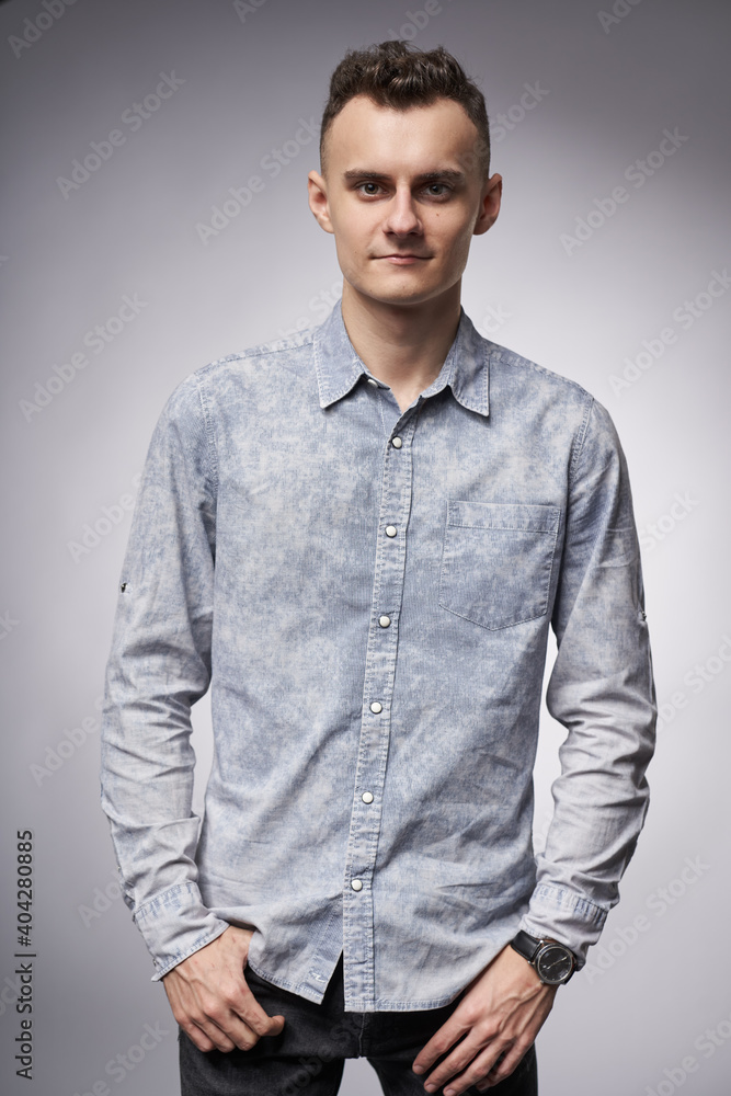 Fototapeta premium Young businessman on gray background