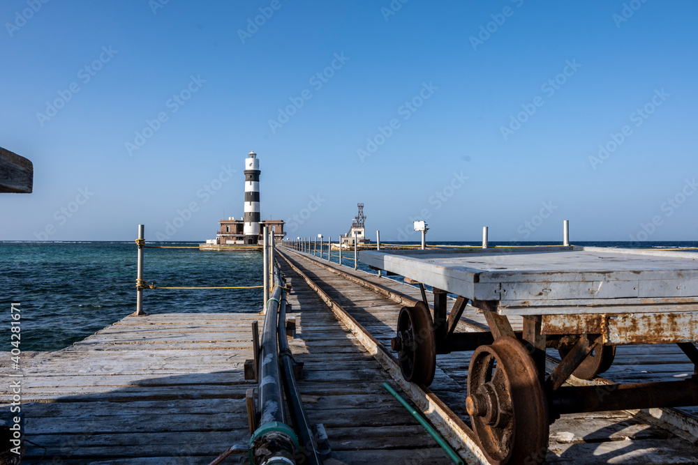 vintage pier and lighthouse in the Red Sea on a sunny day