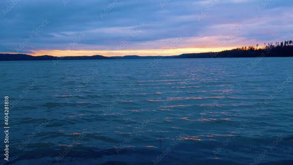 The first rays of the waking sun illuminate the cold waters of the winter lake. The first rays of the waking sun illuminate the cold waters of the winter lake.