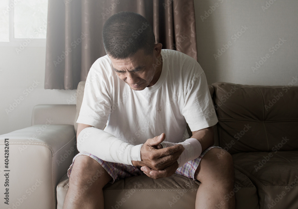 asian man suffering from mental health after an accident on the arm asian man suffering from mental health after an accident on the arm