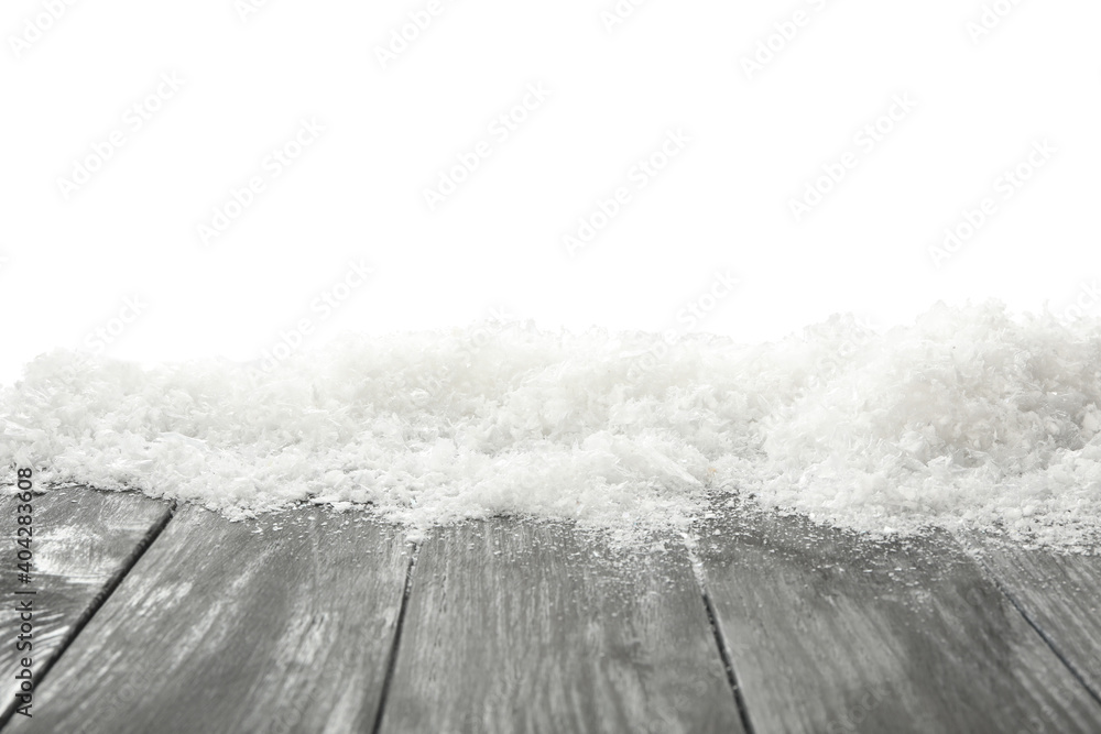 Snow on grey wooden surface against white background. Christmas season