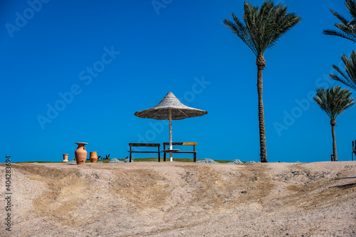 view of a deserted beach on a sunny day with sea and blue sky © константин константи