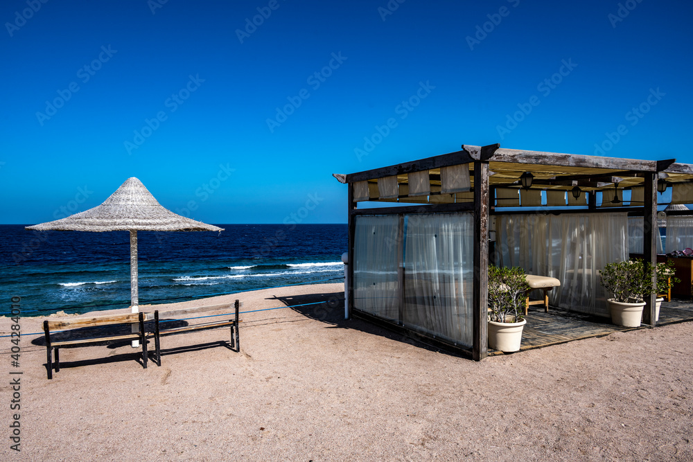Fototapeta premium view of a deserted beach on a sunny day with sea and blue sky