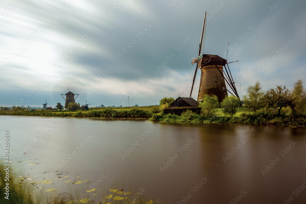 Historic windmill on the water's edge in the Netherlands.