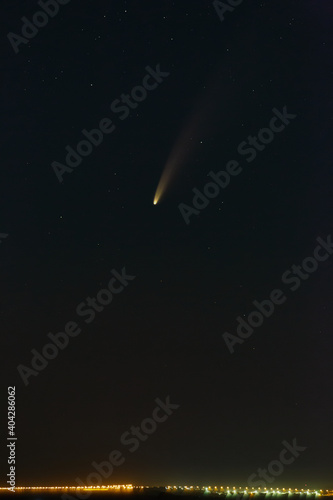 Bright comet C   2020 F3  NEOWISE  in the starry night sky. Deep space object above the horizon.
