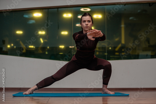 Sexy Girl is streching in the gym.