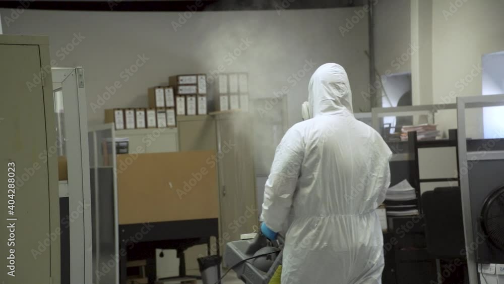 Medical staff wearing protective clothes spraying some chemicals to disinfect contaminated area by contagious covid-19 virus also known as coronavirus. Medical staff wearing protective clothes spraying some chemicals to disinfect contaminated area by contagious covid-19 virus also known as coronavirus.