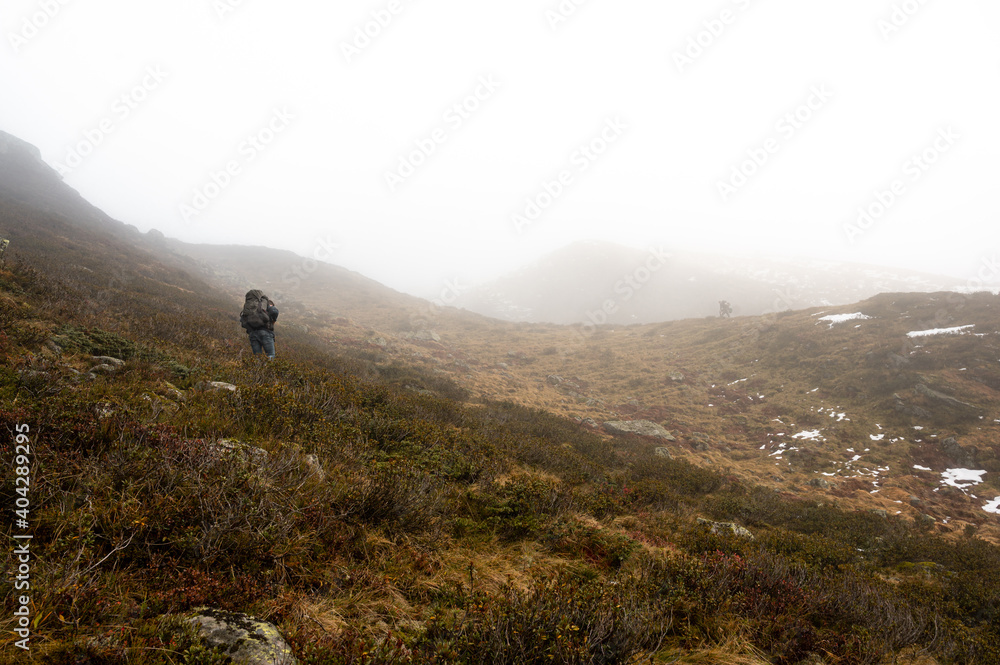 Man Hike in the Meadow and Foggy conditions