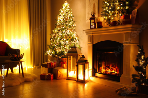 Stylish living room interior with beautiful fireplace  Christmas tree