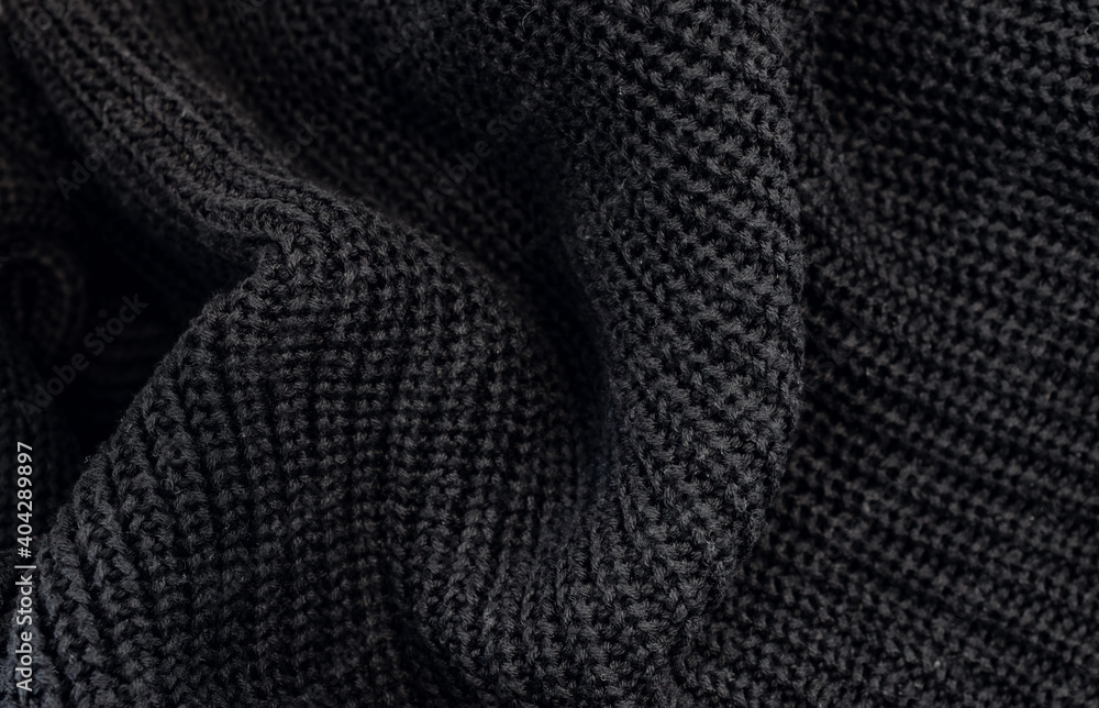 Closeup of the knitted fabric of a black sweater Closeup of the knitted fabric of a black sweater