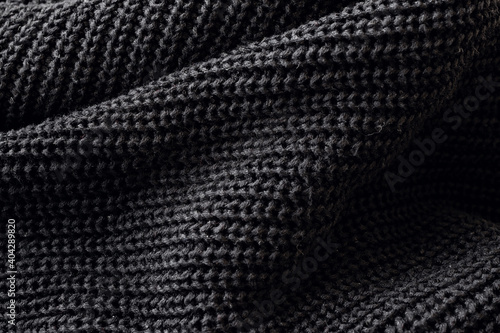 Closeup of the knitted fabric of a black sweater
