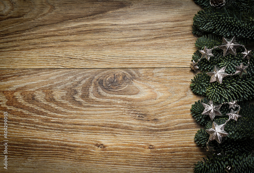 Wooden background with fir branches and silver stars. Wooden background with fir branches and silver stars.