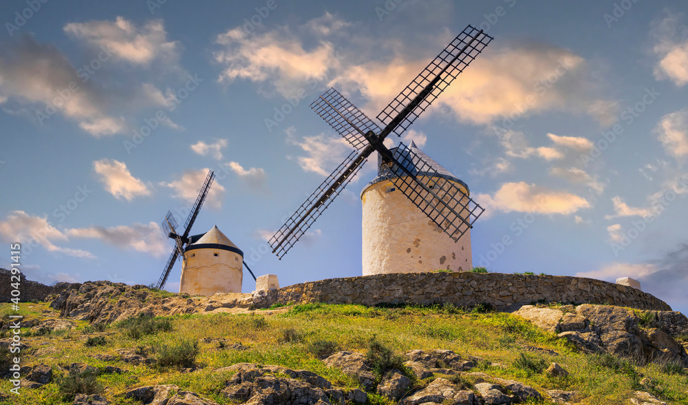 Panoramic landscape with two mills at sunset in the town of Consuegra in Toledo, Spain. Don Quixote Route. Panoramic landscape with two mills at sunset in the town of Consuegra in Toledo, Spain. Don Quixote Route.