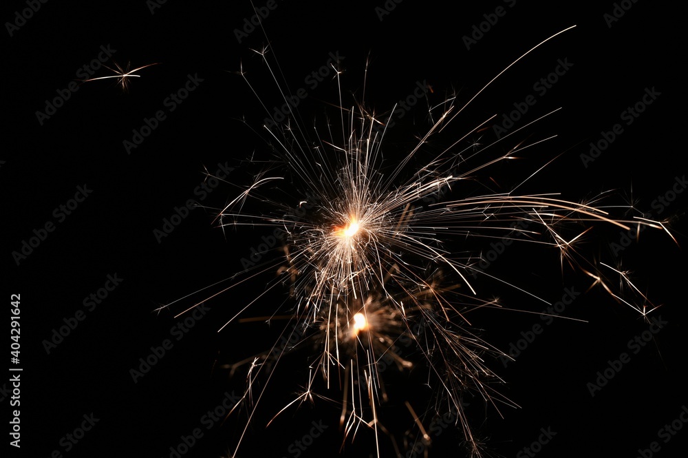 Sparkler - beautiful abstract background. Concept for Christmas and Happy New Year 2021.