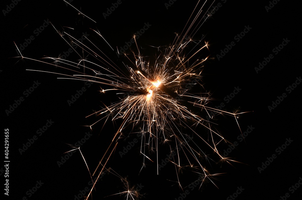 Sparkler - beautiful abstract background. Concept for Christmas and Happy New Year 2021.