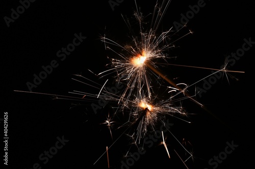 Sparkler - beautiful abstract background. Concept for Christmas and Happy New Year 2021.