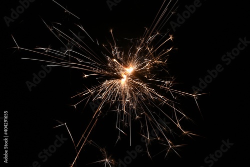 Sparkler - beautiful abstract background. Concept for Christmas and Happy New Year 2021.