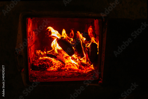 Fire in the stove, wood, sparks, on a black background