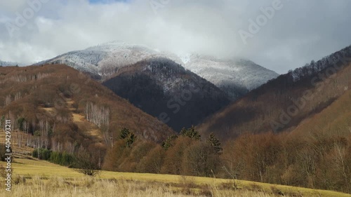 Timelapse over Mala Fatra mountains in windy winter day, Slovakia. Typical slovakian countryside of fields and meadows.