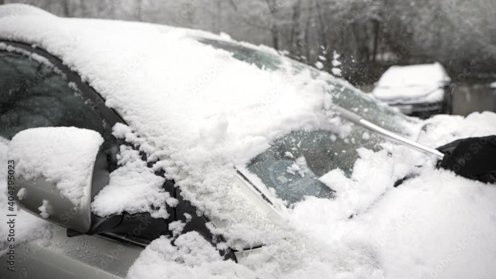 Brushing snow off the windshield of a car on a cold winter day, slow motion footage
Brushing snow off the windshield of a car on a cold winter day, slow motion footage