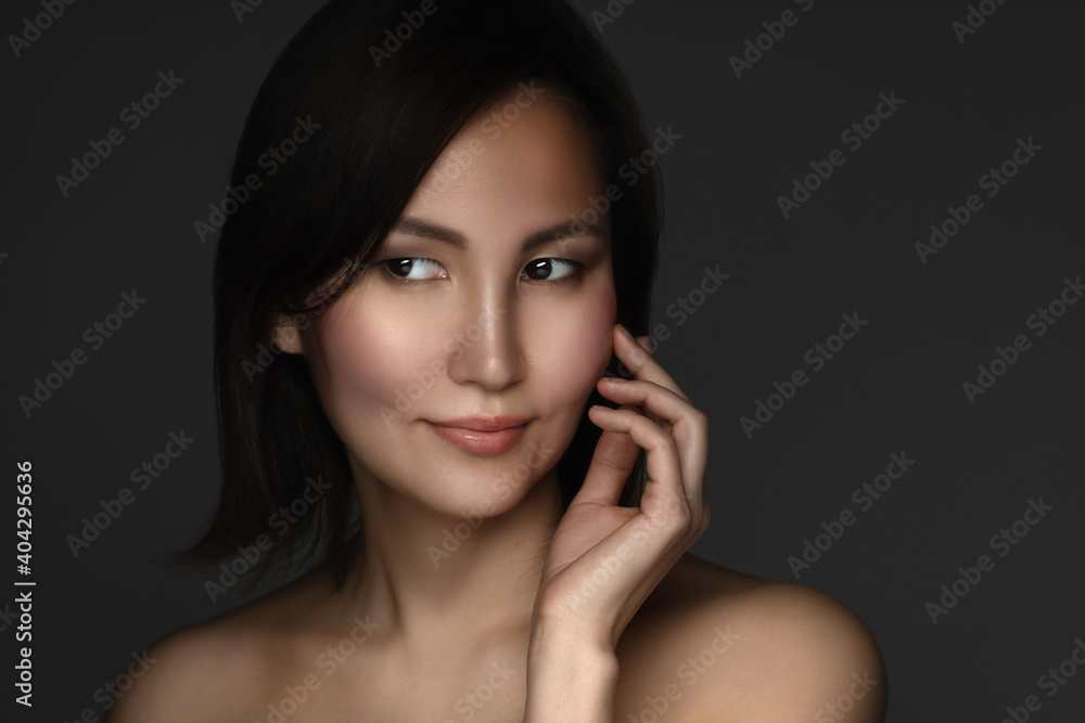 Portrait of young and beautiful asian woman on gray background Portrait of young and beautiful asian woman on gray background