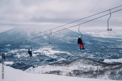 Skiers on chair lift photo