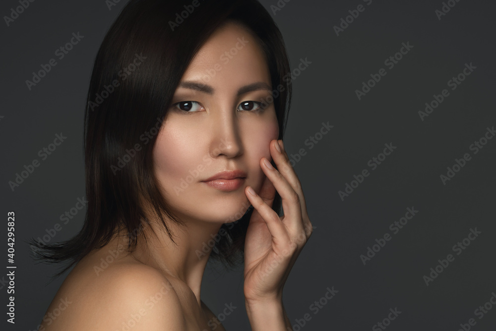 Portrait of young and beautiful asian woman on gray background Portrait of young and beautiful asian woman on gray background