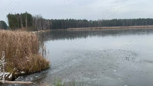 Winter landscape on a pond. Ice on lake. photo