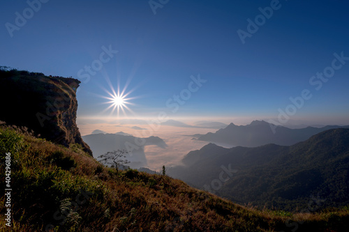 Beautiful natural landscape on the hilltop with the winter sunrise at Phu Chi Fa Viewpoint, Chiang Rai, Thailand.